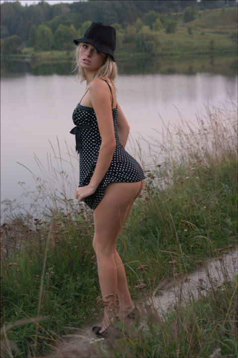 Cute Nastya posing by the river in this sexy dress and flashing her nice ass
